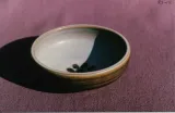 Cat bowl, pale refired sea-green w/ dark brown exterior & paw print